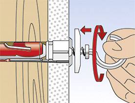 The illustration shows a hand twisting an anchor fixing into a wall. The anchor expands within the material to secure itself.