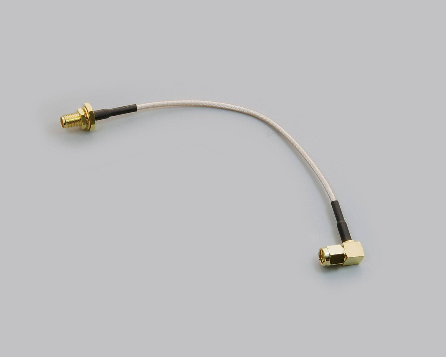 Coaxial cable with two gold-coloured connectors, one straight and the other at a right angle, against a grey background.