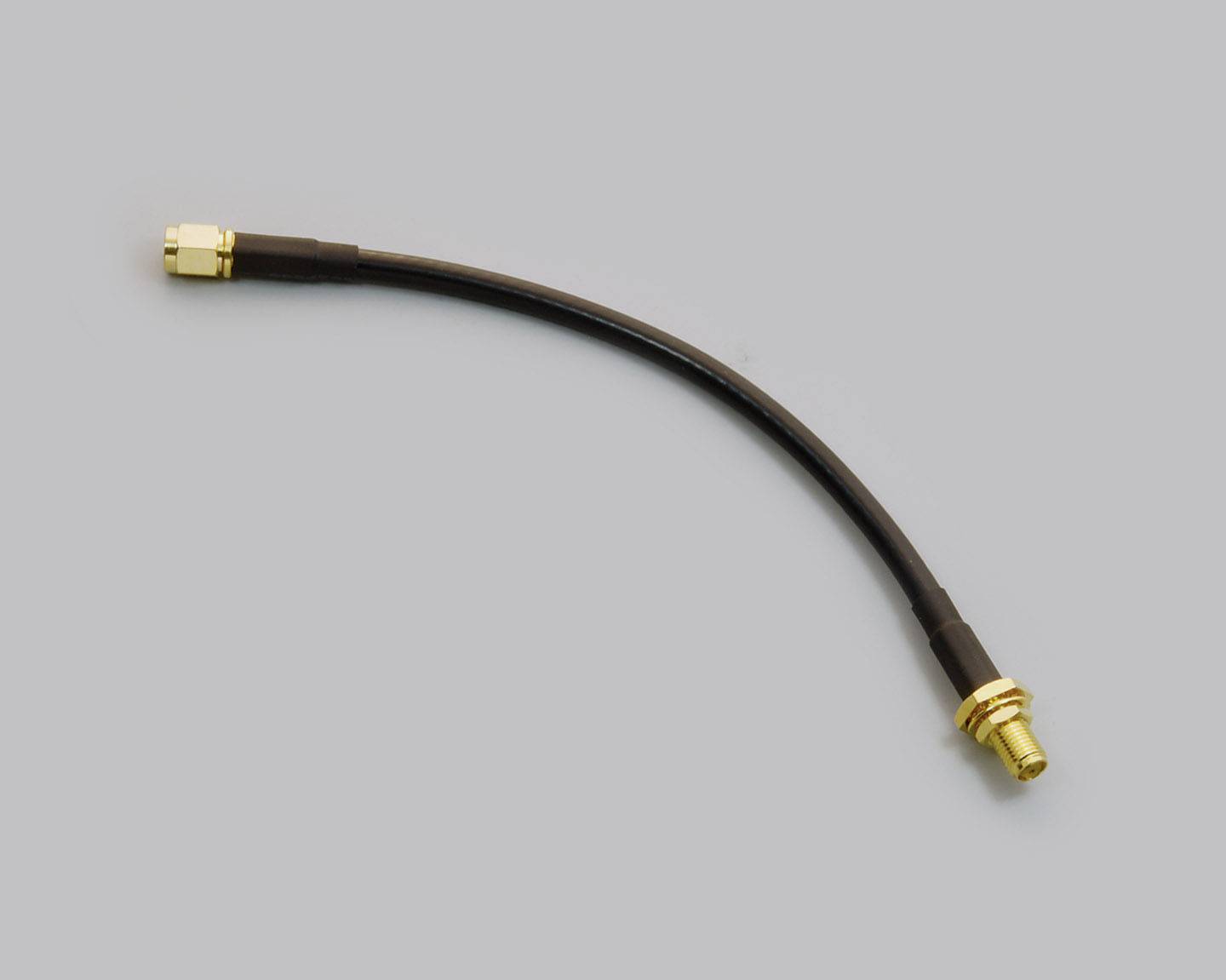 Black coaxial cable with gold-plated connectors at both ends on a grey background.