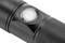Close-up of a black torch with a textured grip, showing the power switch in the centre.
