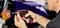 A person is repairing a motorbike and using a cordless screwdriver to tighten the indicator.