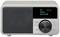 Digital radio with grey casing and black speaker. Display shows 'DAB', 'Coffee', 'Time to Chill'. Large volume button.