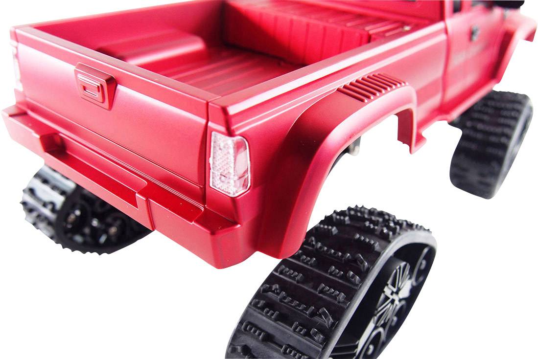 Red toy car with caterpillar tracks instead of wheels, showcasing a modern design for miniature off-road adventures.