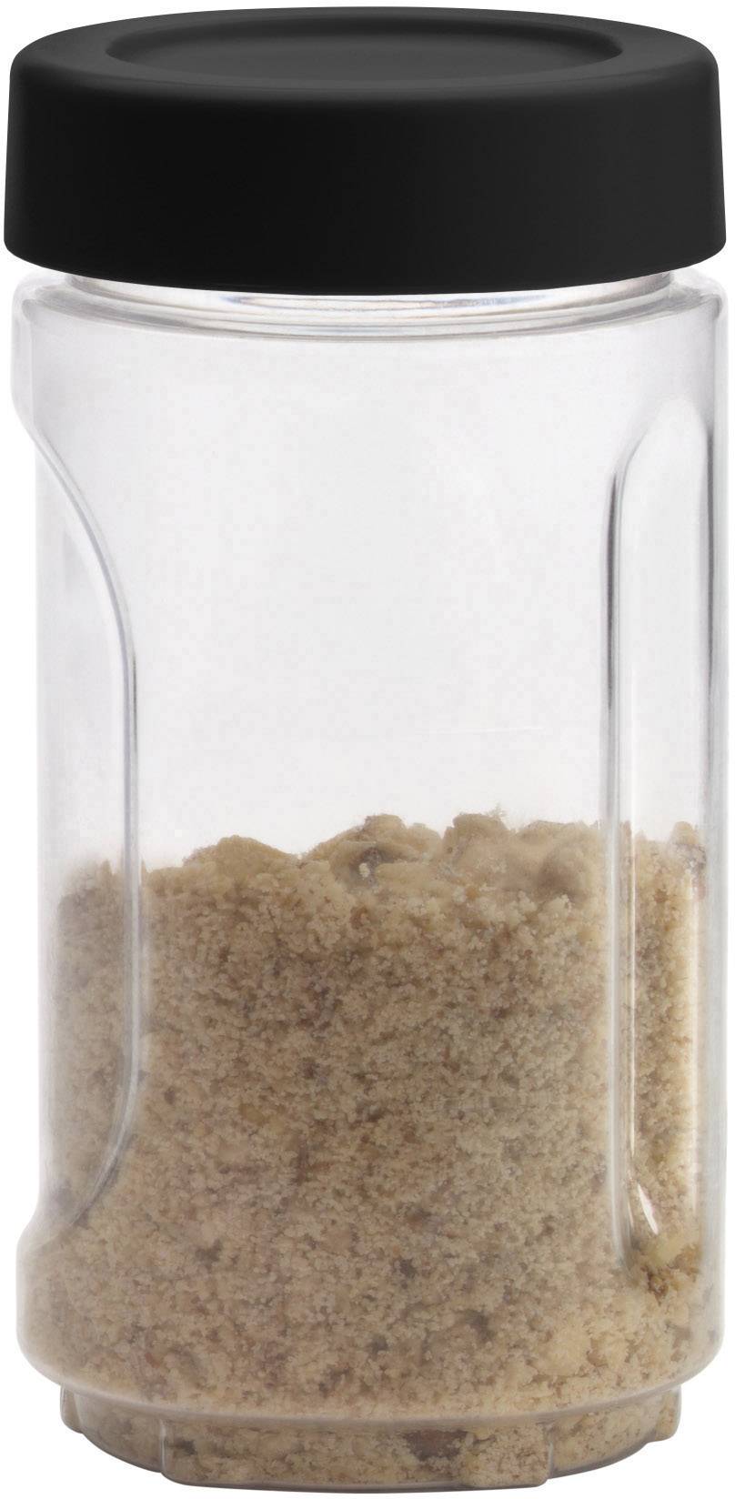 A transparent glass with a black lid, filled with brown sugar.