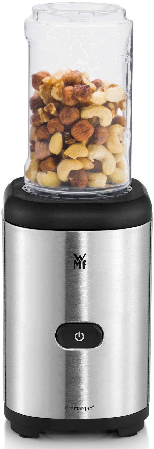 An electric blender with a glass full of nuts ready to be chopped. Device in metallic finish with black accent.