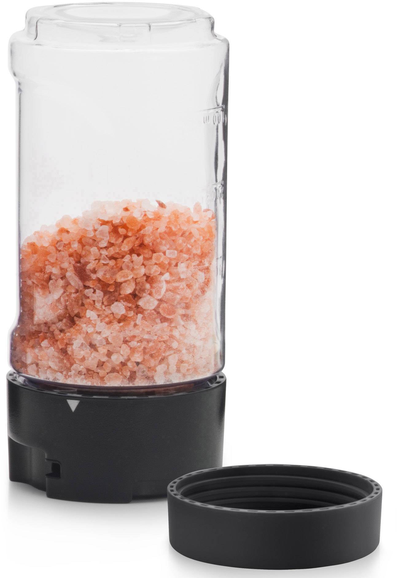 Electric pepper mill with transparent container, filled with pink Himalayan salt. Black lid lies beside it.