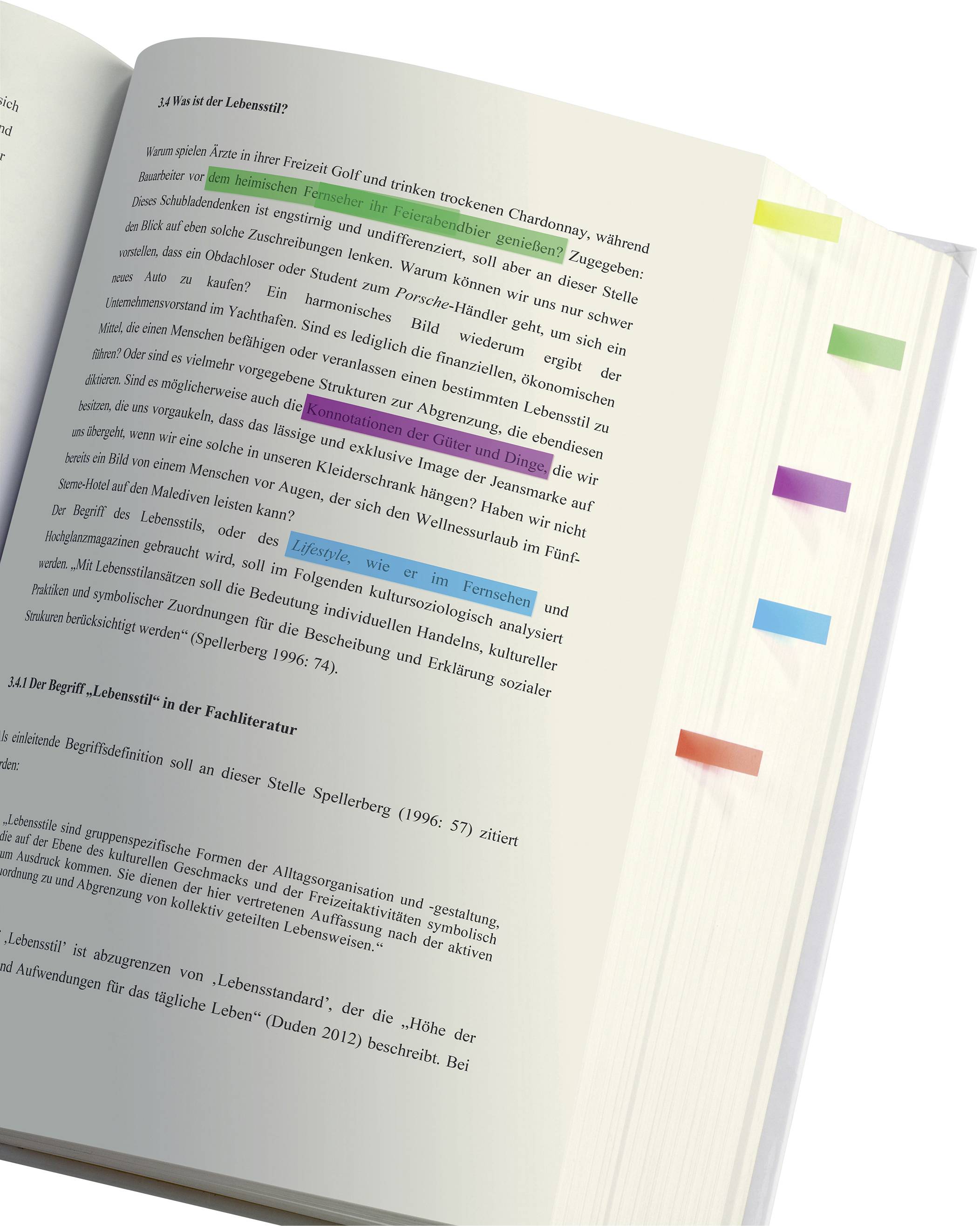 An open book with coloured highlighter marks on the pages, highlighting different paragraphs in the text.