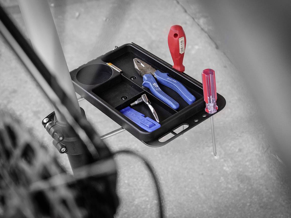 Tool tray with pliers, screwdriver and other hand tools, ready for bicycle repair.