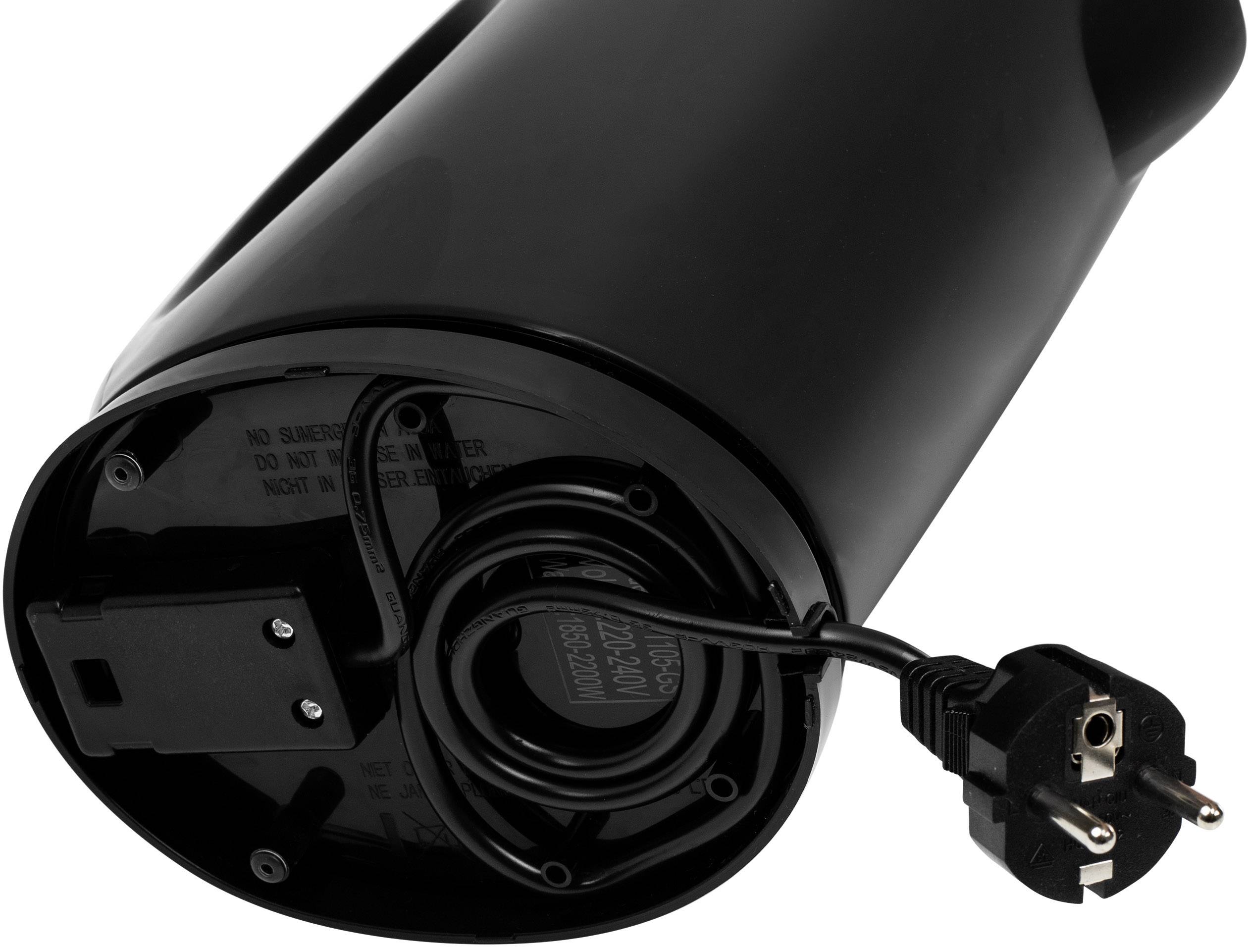 A black kettle lying on its side, with visible power cable and Schuko plug.