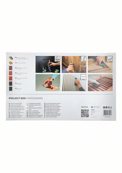 The reverse side of a sandpaper project box displays instructions and illustrated steps for handling sanding work.