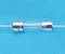 A glass fuse tube with metal end caps, against a blue background.