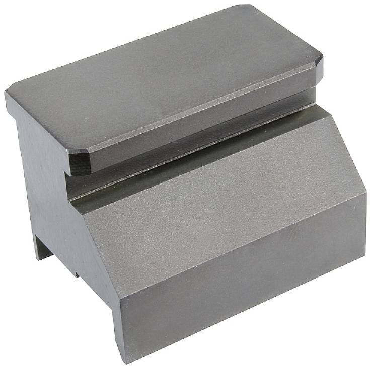 A heavy metal block with a bevelled and a flat surface, potentially a machine component or tool.