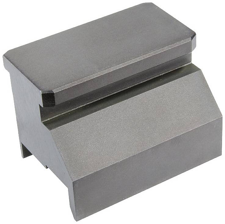 A metallic, prismatic block with a rectangular front face and a chamfered lower section, likely a machine component.