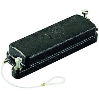 A black rectangular object with a metal fastener. An embossed design is visible on the lid, with a fabric-like cable attached at one end.