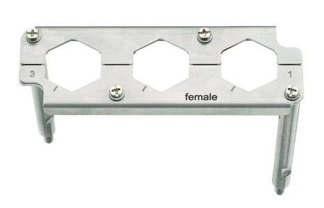 Metal bracket with three hexagonal cutouts, numbered 1 to 3, marked with the inscription 'female'. Used for cable management.