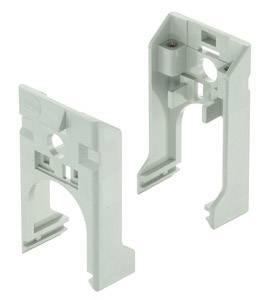 Two grey plastic mounting brackets for electronic device installation, with round cutouts for cable routing.