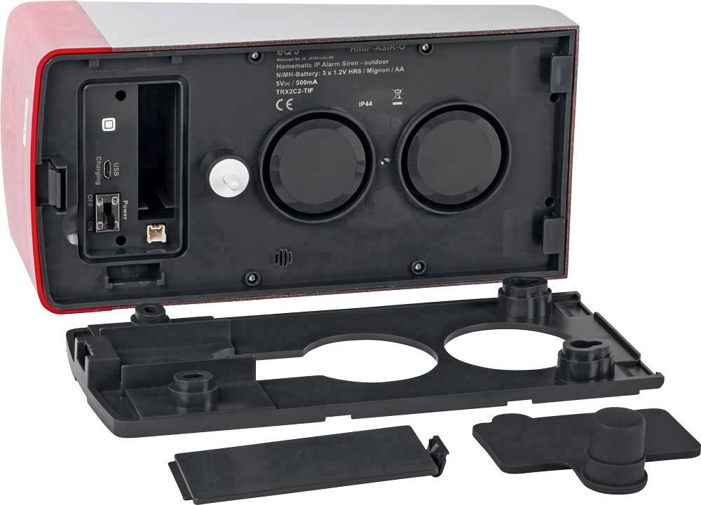 A red electronic device with its cover removed reveals two round speakers, a USB port, and a network connection.