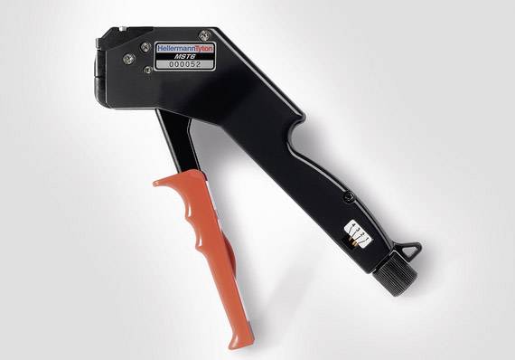 A black cable tie tool with a red handle, suitable for securing cable ties; model designation is on the front.