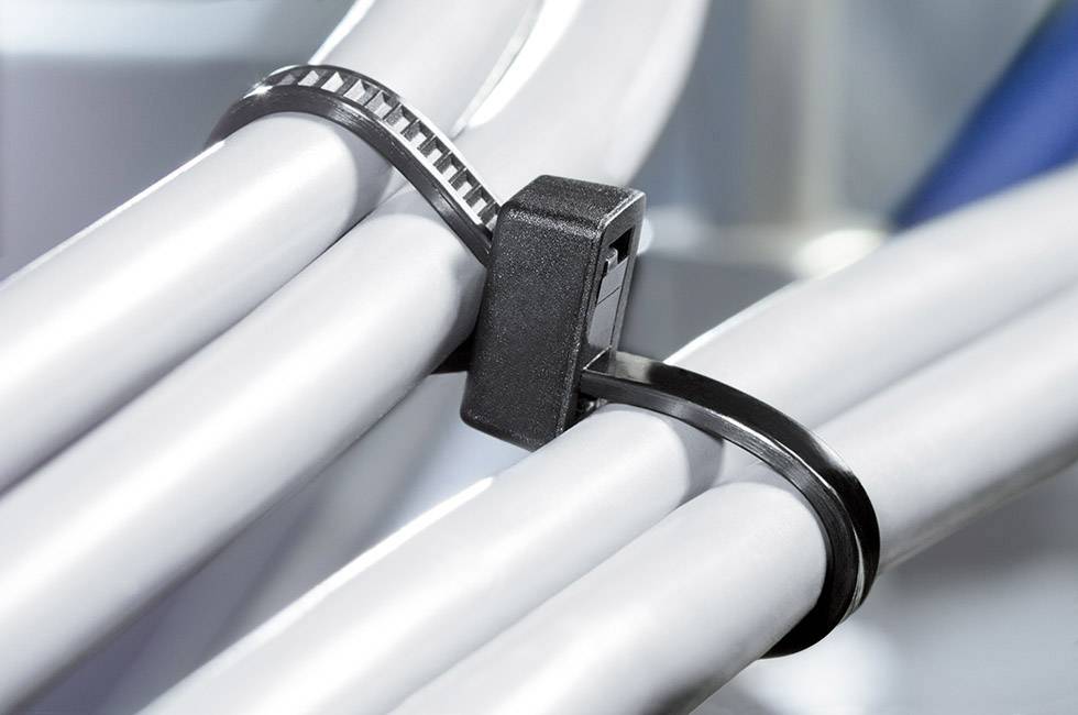 A black cable tie holds several grey cables together.