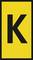 A yellow sign with a large black letter 'K' in the centre.