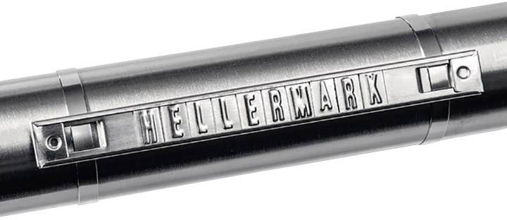 A metallic stamp with the inscription 'HELLERMARK' in raised letters on a round cylindrical object.