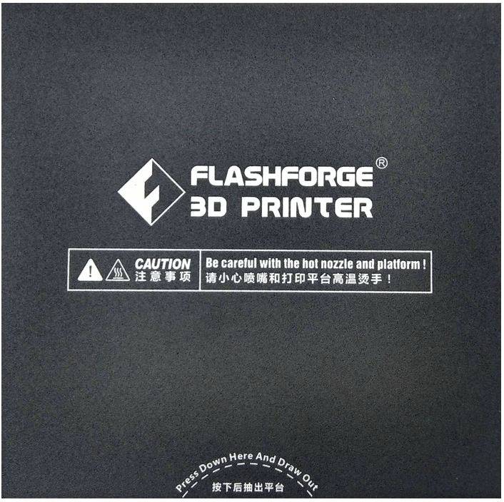 The image shows the inscription 'FLASHFORGE 3D PRINTER' with a warning: 'Caution - hot nozzle and platform.'