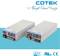 Here is the translation to British English:<br><br>'Tis an image of two parallel power supply modules with ventilation grilles and connection terminals, placed on a turquoise surface. Top right reads 'COTEK'.