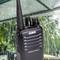 An Alinco radio is visible in the rain under a glass roof. It is water-resistant, which emphasises the device's robust nature.