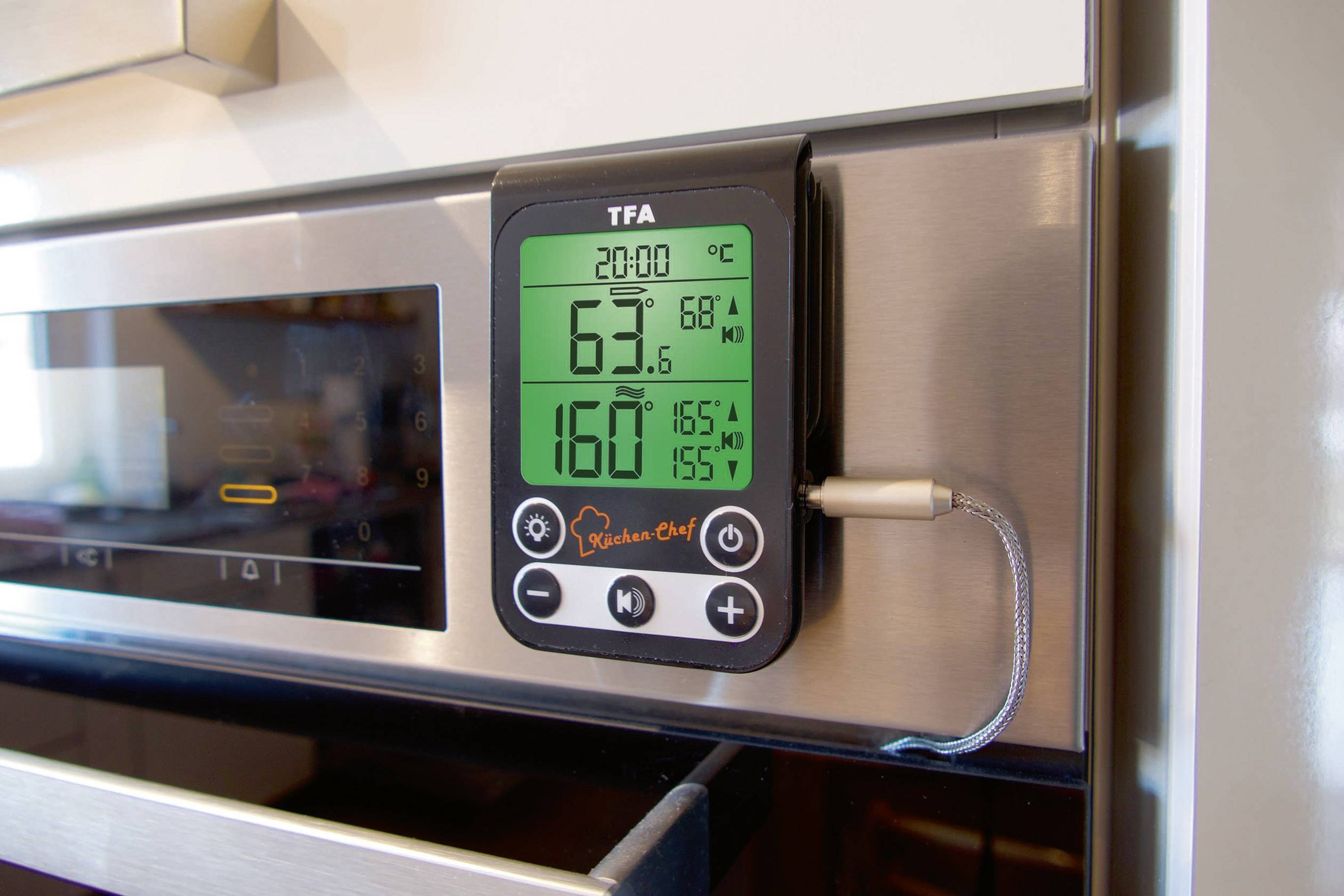 A digital kitchen timer displays the internal temperature of an oven: '63°C' and a target temperature of '160°C'.