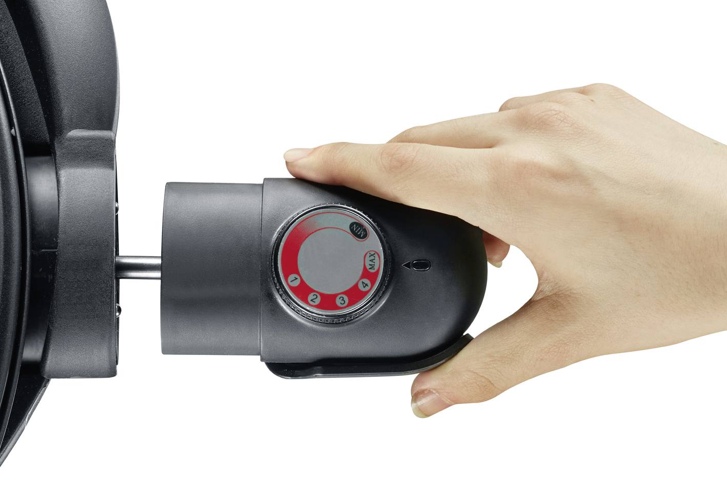 A hand is holding a rotary mechanism with a scale on a black device. The focus is on the handling of the device.