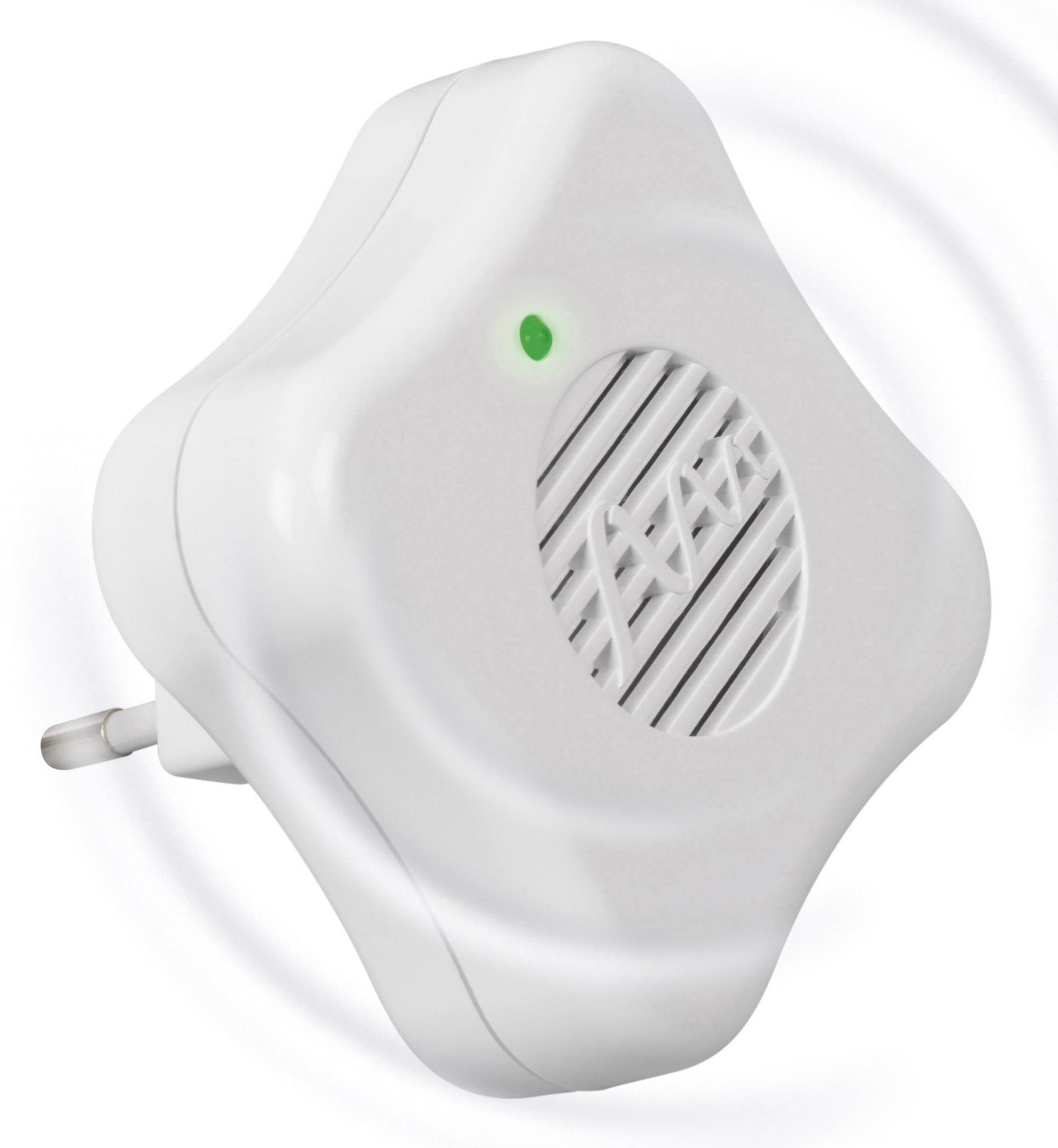 A white, square device with rounded corners is plugged into a socket. A green light is illuminated in the top left corner.