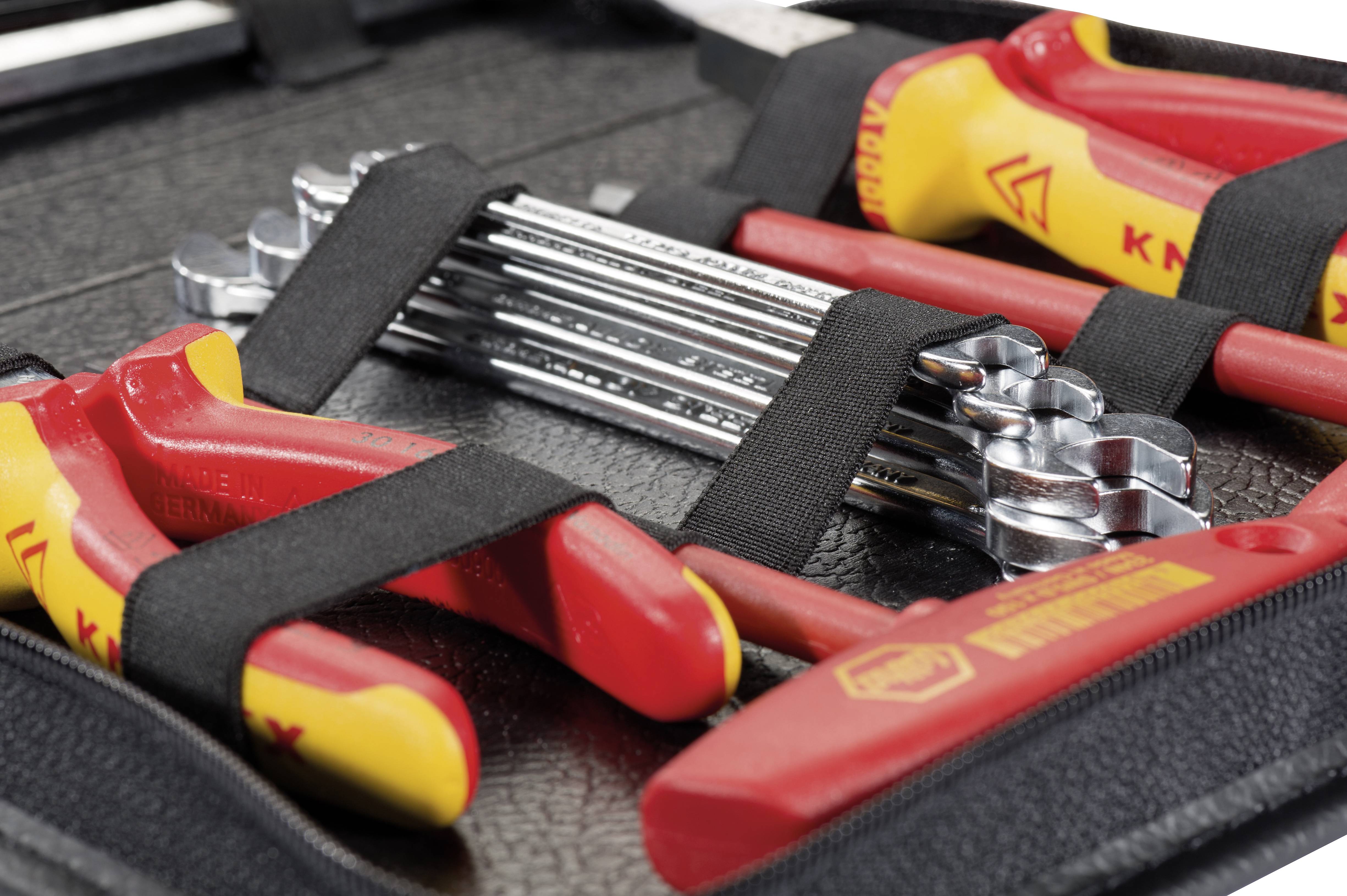 A tool case with various tools, including red pliers, spanners, and other hand tools, neatly arranged.