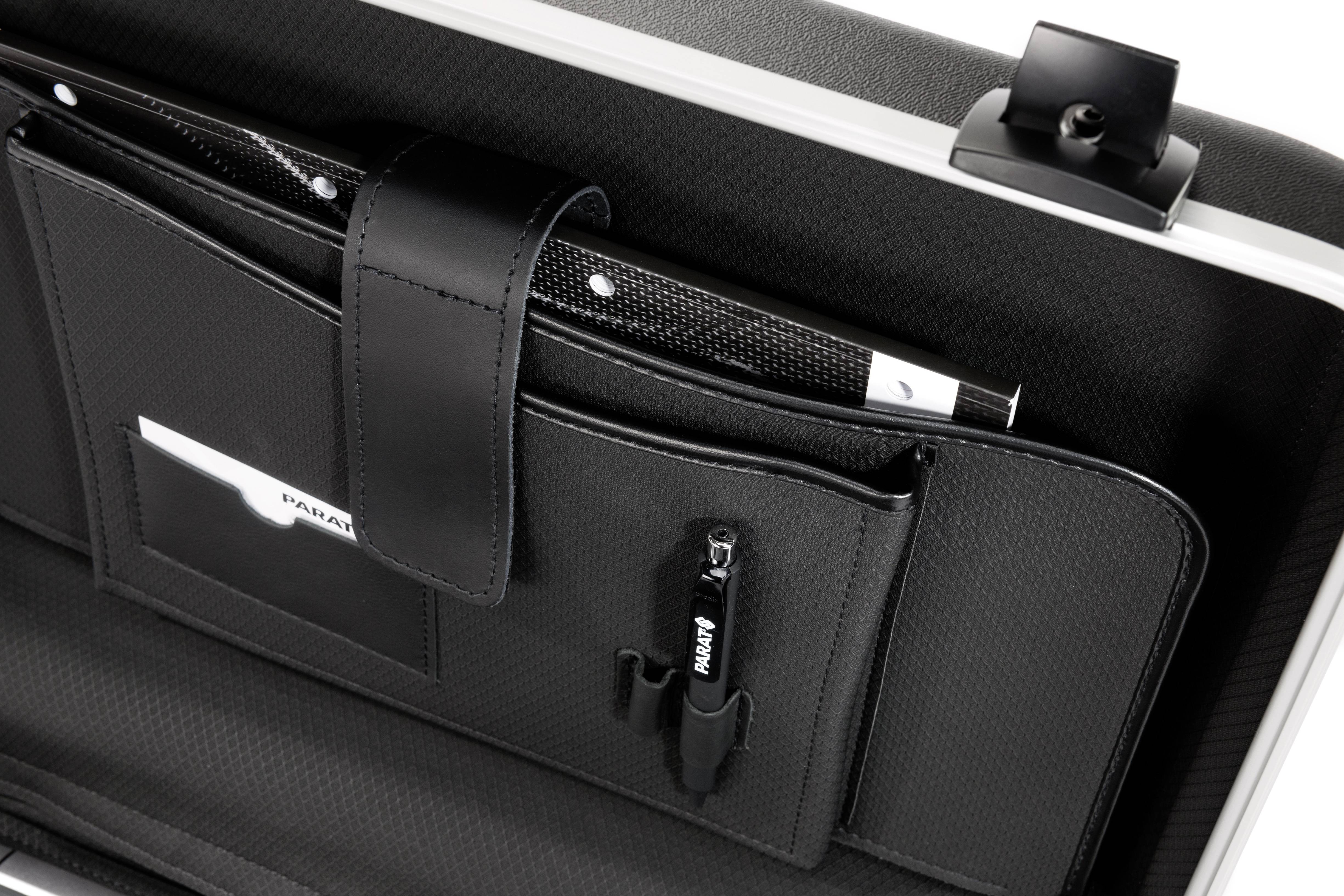 Black briefcase seen opened, displaying compartments with documents, pens, and a set of keys.