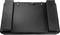 A black, rectangular item with a structured surface and two raised edges on the sides. Looks like a laptop bag.