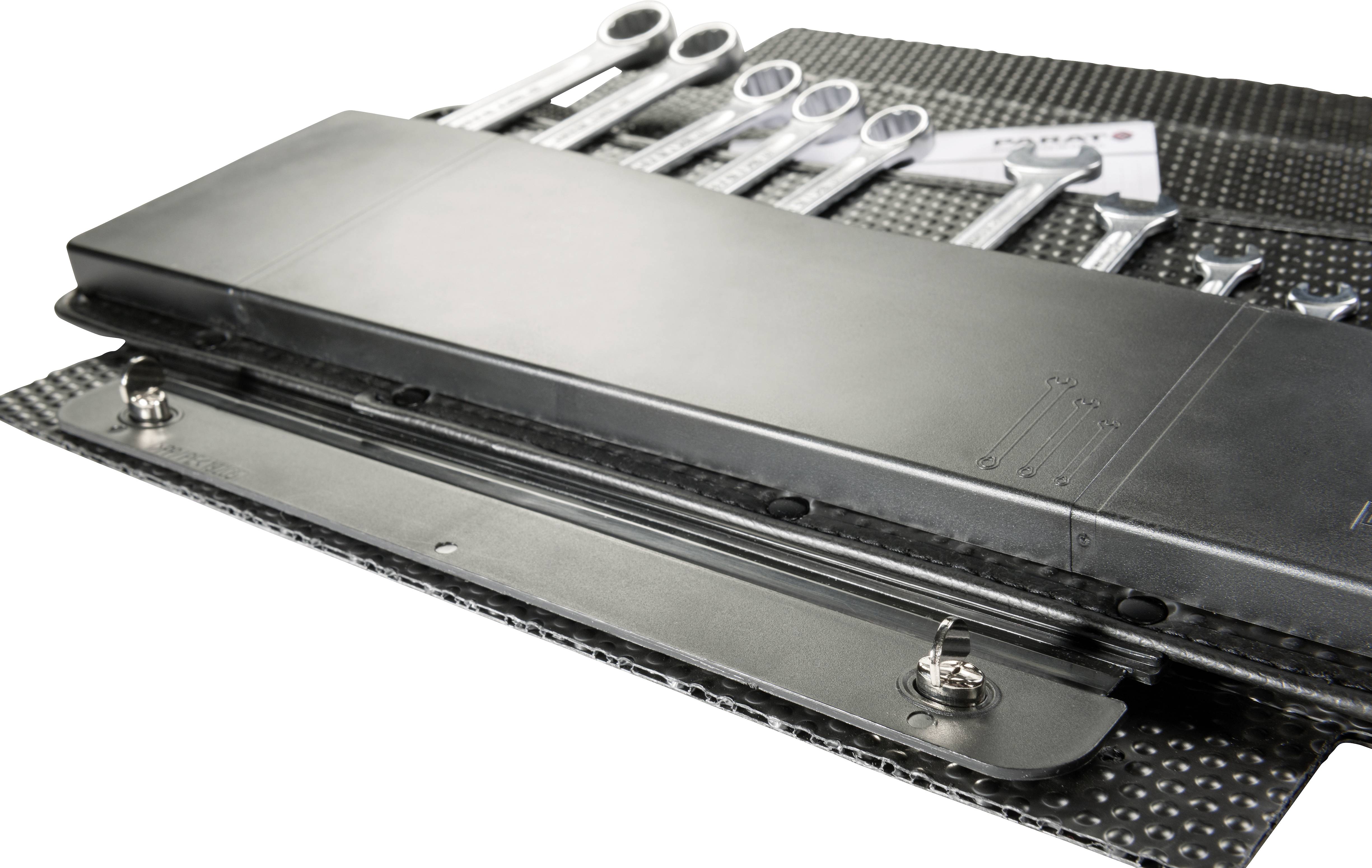 'Set of spanners in various sizes arranged on a metal plate, with screws lying beside them.'