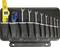 A tool bag with open spanners in various sizes, a craft knife and a yellow spirit level.