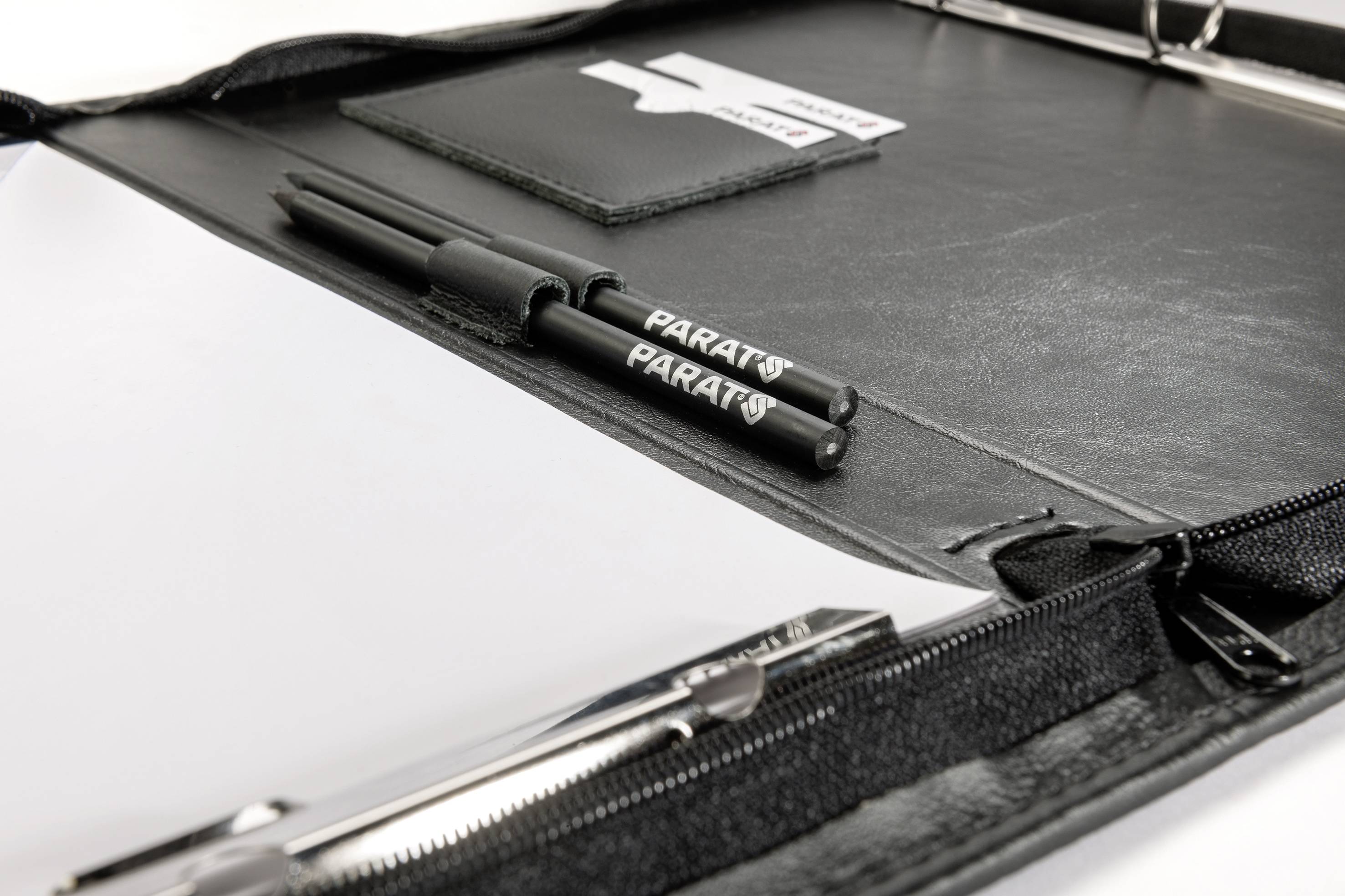Opened leather briefcase in black, with two 'PARAT' ballpoint pens inside, a notepad and a business card holder.