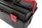 Black toolbox with red locks and handles. A centimetre scale is visible on the lid.