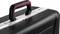Black hard-shell suitcase with red handle and silver lock; brand name 'PARAT' visible on a metal strip.