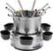 A silver fondue pot with eight colourful fondue forks and six black ramekins on a round base.