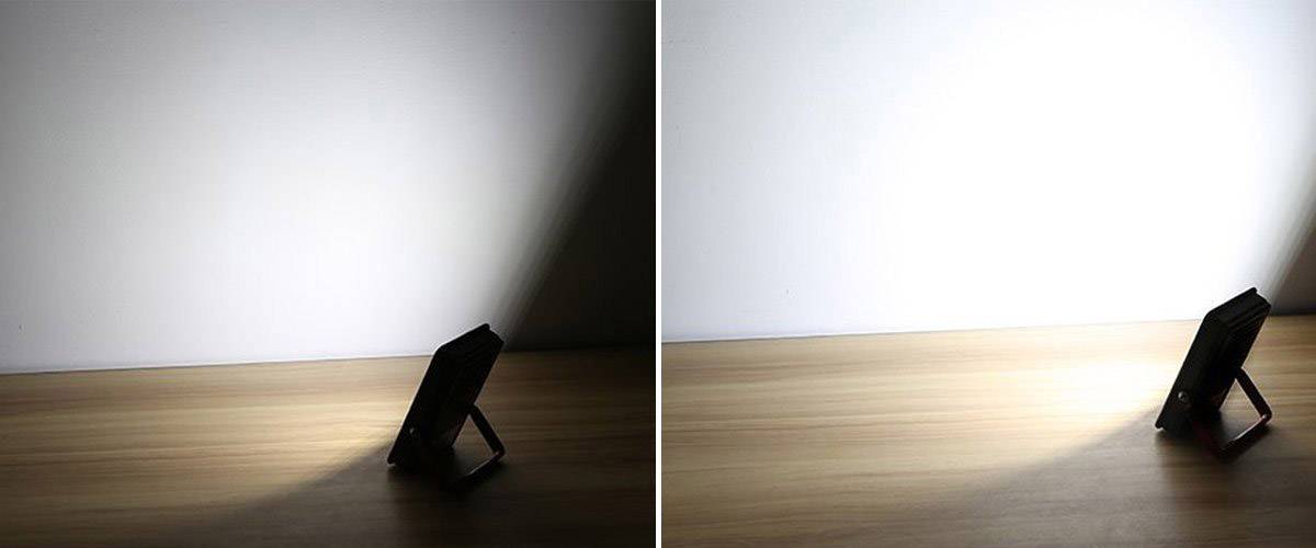 'Two images of an LED stand on a wooden table, one with dimmed light and one with brightly switched-on light, casting onto the wall.'