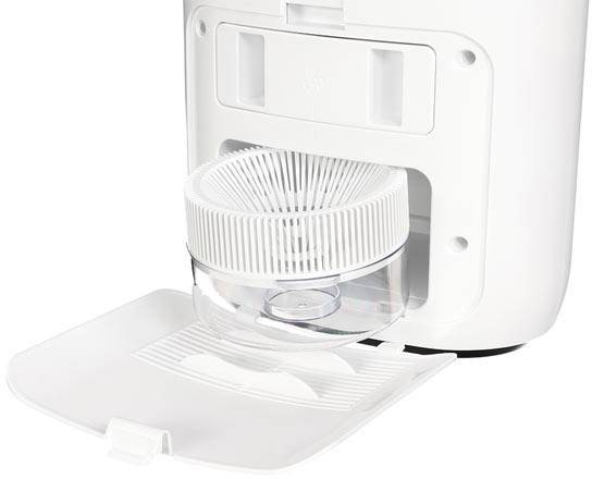 A humidifier with its water tank lid open. The round filter is visible. The device is white and standing upright.