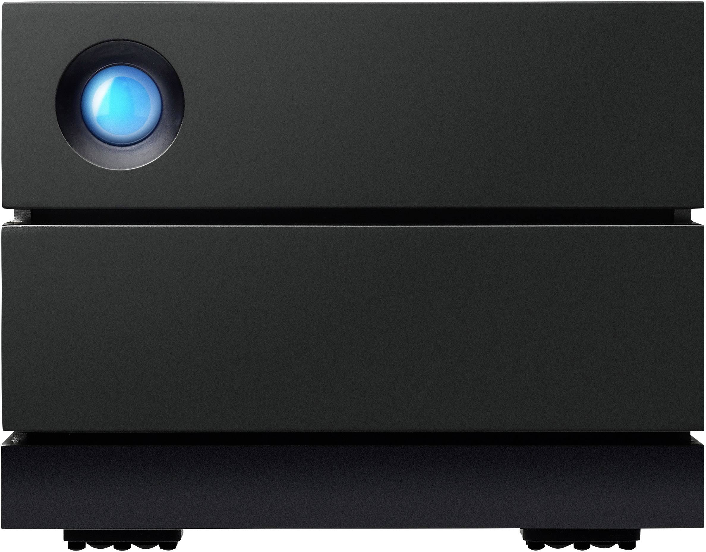 A black external hard drive enclosure with a blue illuminated ring on the top left, sits on a table.