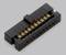 Black 24-pin electrical connector with gold-plated contacts, on a grey background.