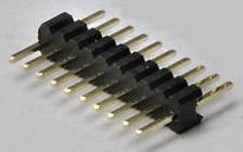 A row of gold-plated pin headers typically used in electronic circuits to connect components.