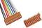 An orange connector with multi-coloured cables is shown with its matching counterpart, ready to be connected.