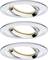 Three round, recessed ceiling spotlights made of gleaming metal, slightly angled. Lighting in warm white.