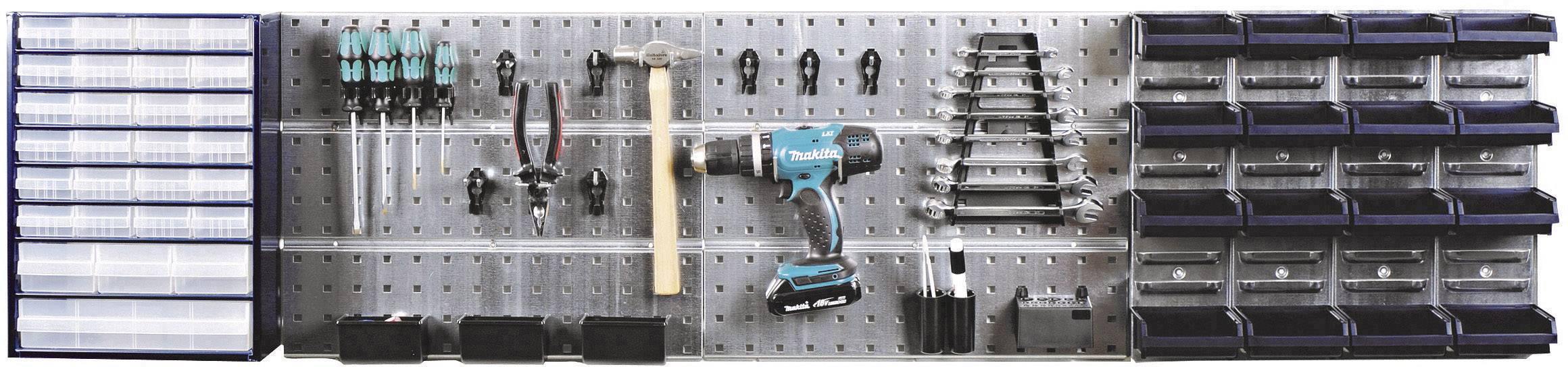 Tool wall with drawers, screwdrivers, hammer, drill and pliers organised in holders on a metallic board.