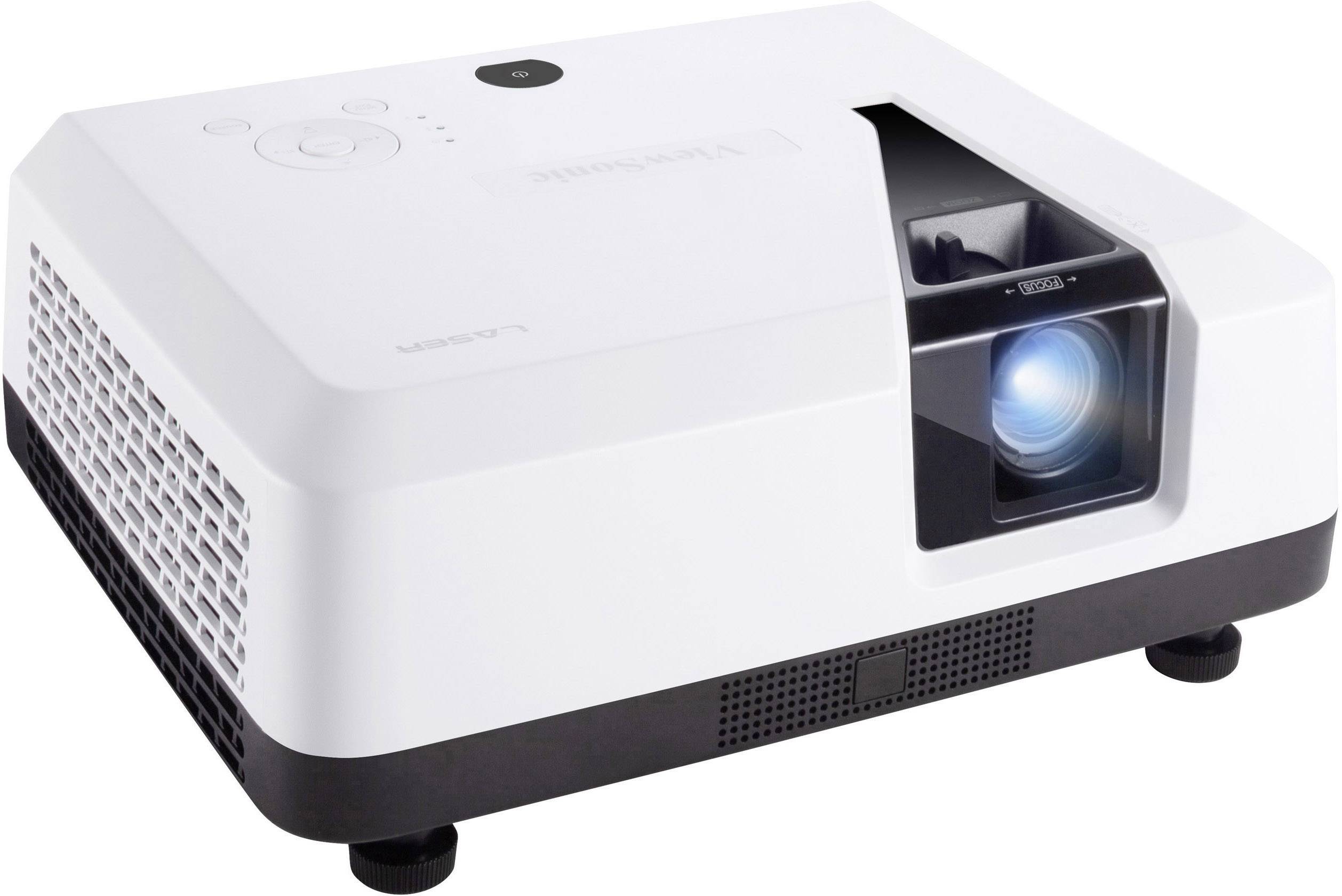 A white, compact projector with ventilation grilles on the side and a gleaming lens, sits on a flat surface.
