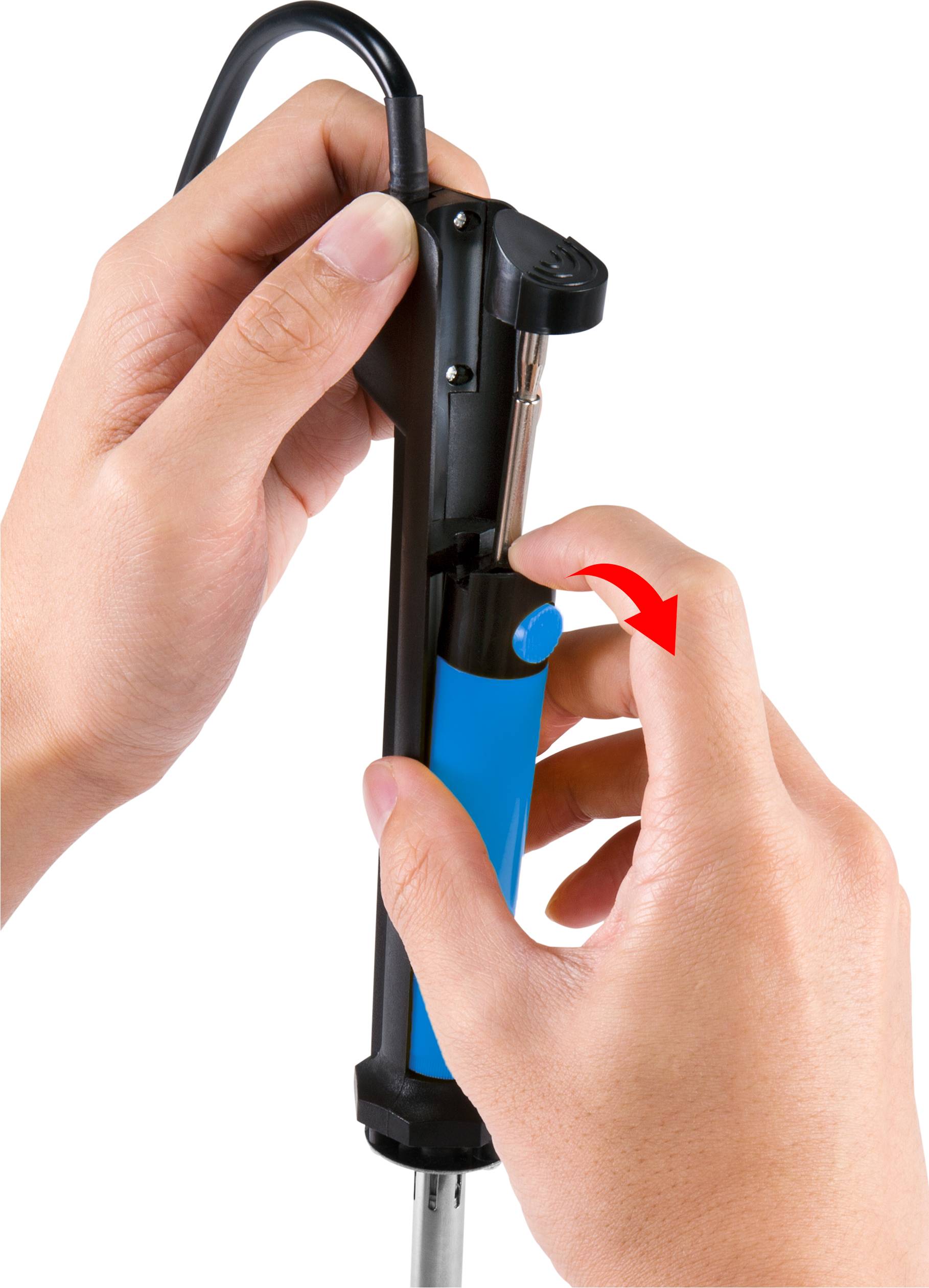 Hands are operating a soldering iron accessory, with a screw being manipulated. A red arrow indicates the direction of rotation.
